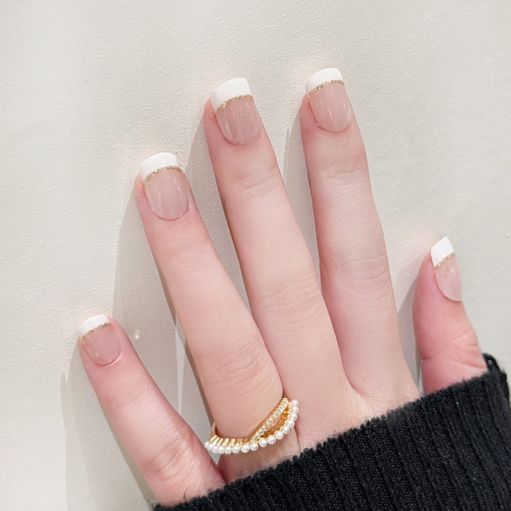Artful nail extensions with elegant French tip and gold accents Kalsten