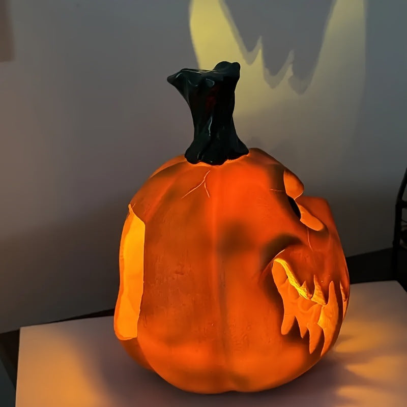 Ceramic pumpkin lantern with hollowed-out spooky face and tealight compartment