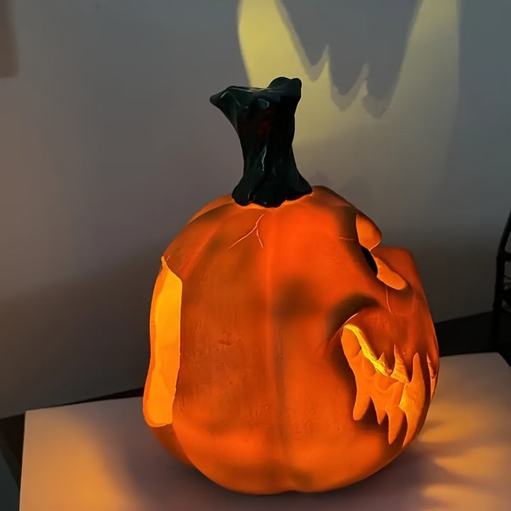 Ceramic pumpkin lantern with hollowed-out spooky face and tealight compartment