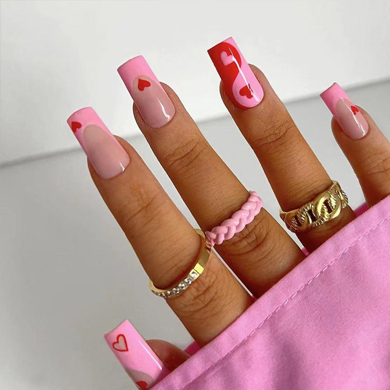 Artificial nail art with heart design and glitter accents Kalsten