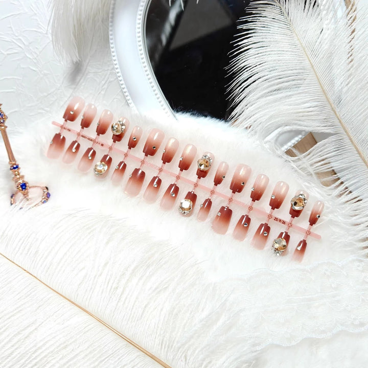 Artificials nails in elegant ombre style with rhinestone embellished applications Kalsten