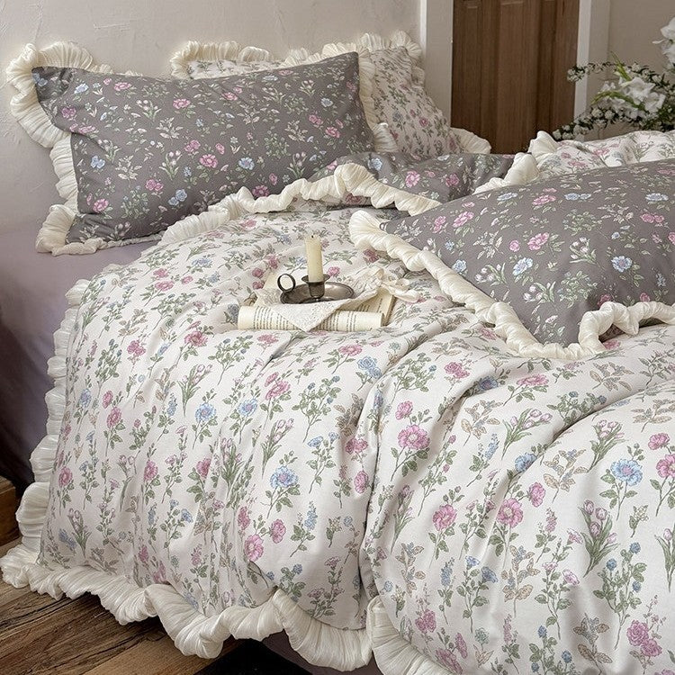 Reversible quilt in vintage botanical design with ruffle and matching pillowcases