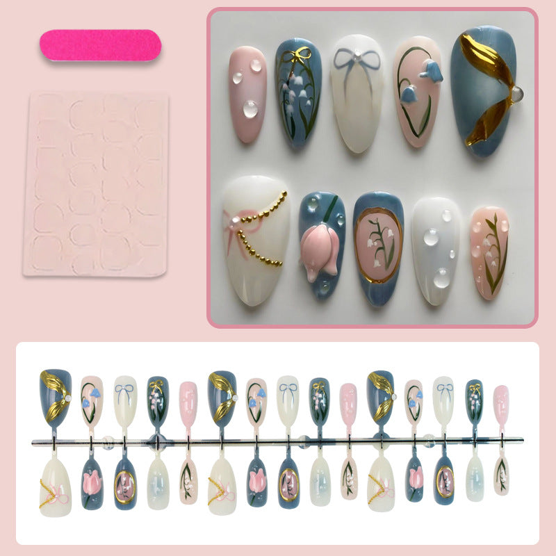 Acrylic nail set with floral design and elegant gold embellishments Kalsten