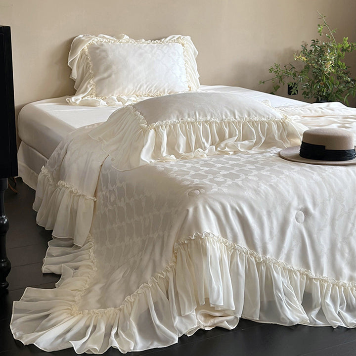 Elegant satin bed linen set with generous ruffle trim and tone-on-tone jacquard pattern