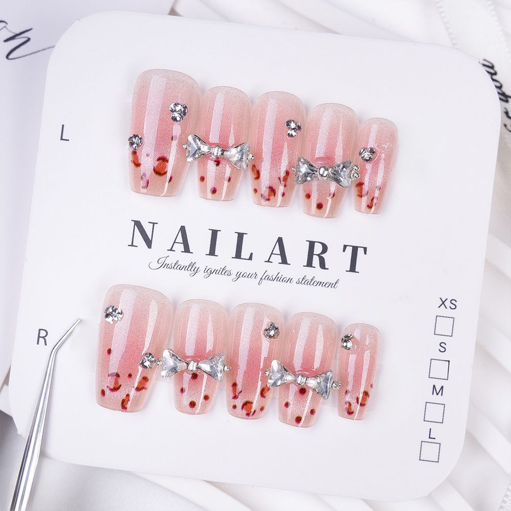 Art nails with delicate rhinestone and bow accents Kalsten