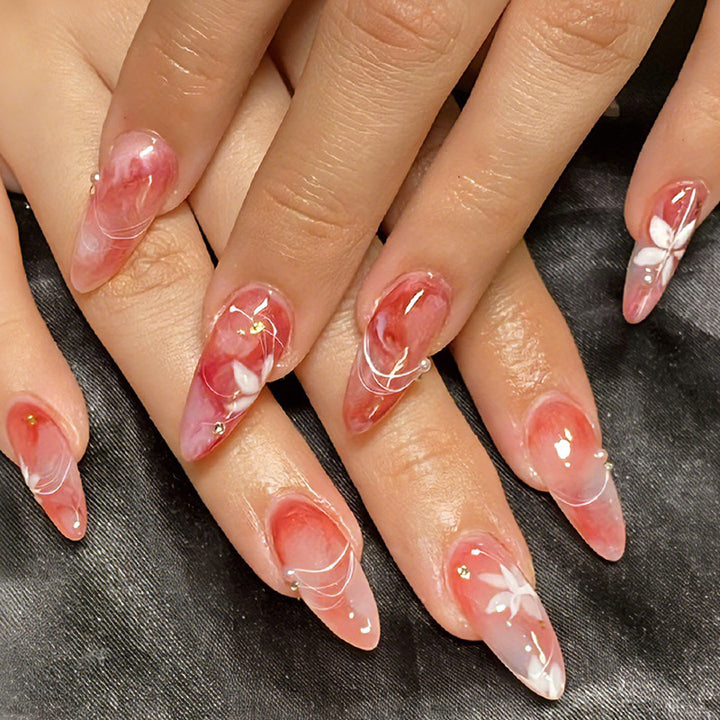 Acrylic nail set with elegant ombre design and floral accent Kalsten