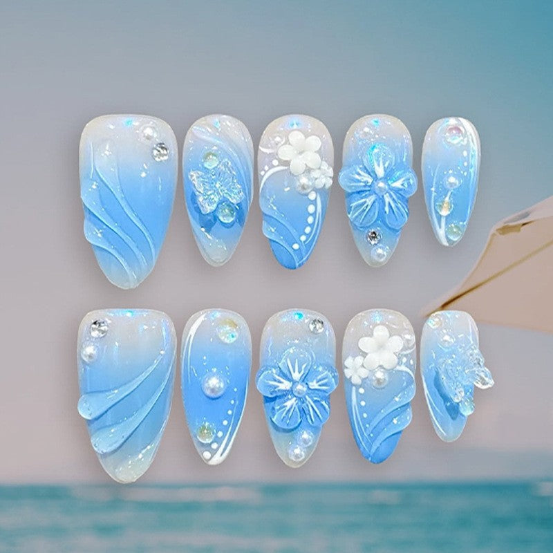 Artificial nail creation with floral designs and glitter accents Kalsten