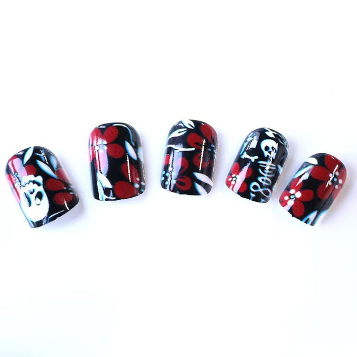 Creative nail art with skull motif and floral elements Kalsten