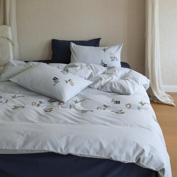 Embroidered cotton bedding set with delicate wildflower embroidery and percale texture