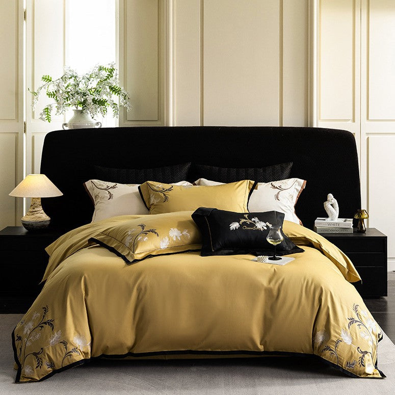 Luxurious embroidered satin bed linen set with floral corner motif and contrast piping