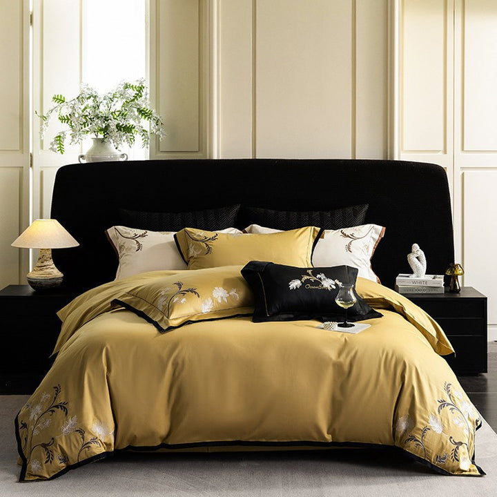 Luxurious embroidered satin bed linen set with floral corner motif and contrast piping