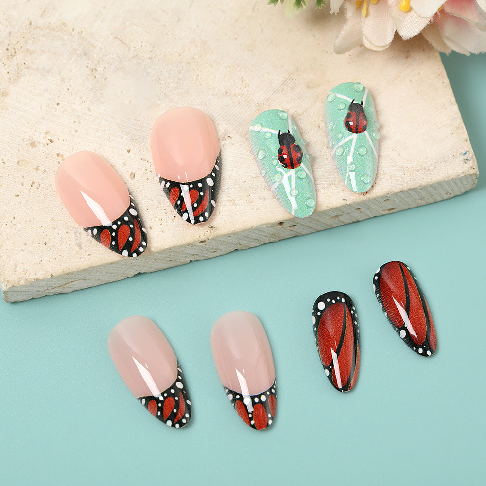 Creative nail art with elaborate butterfly and flower designs Kalsten