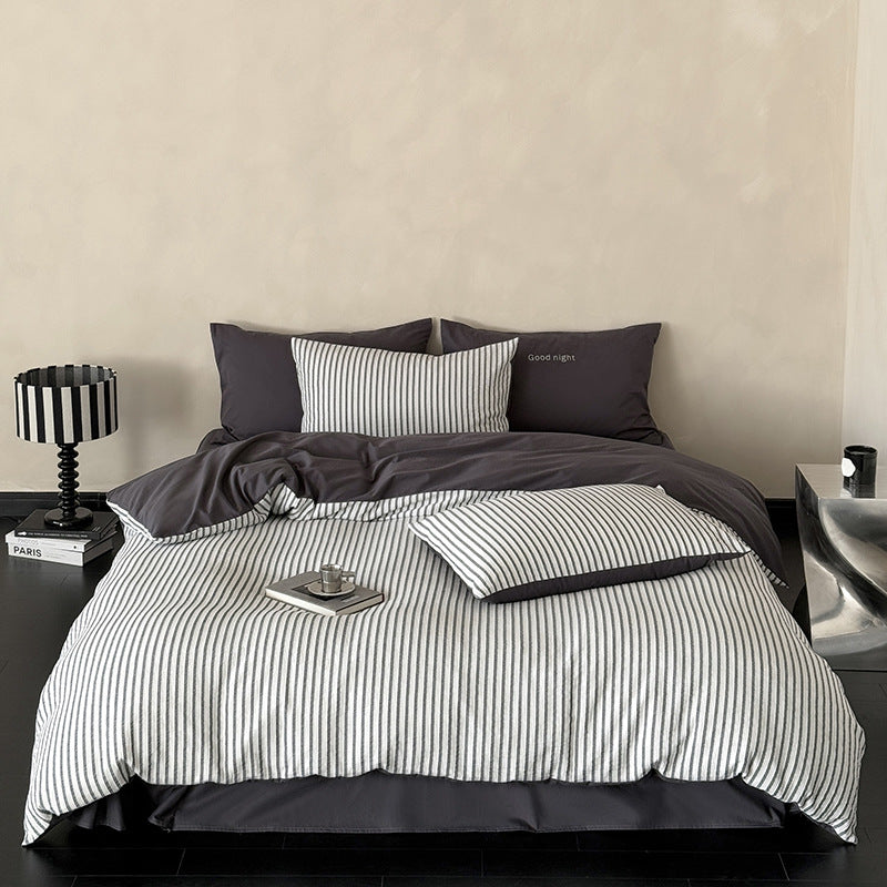 Modern bedding set made of breathable cotton muslin with a fine stripe pattern and reversible function