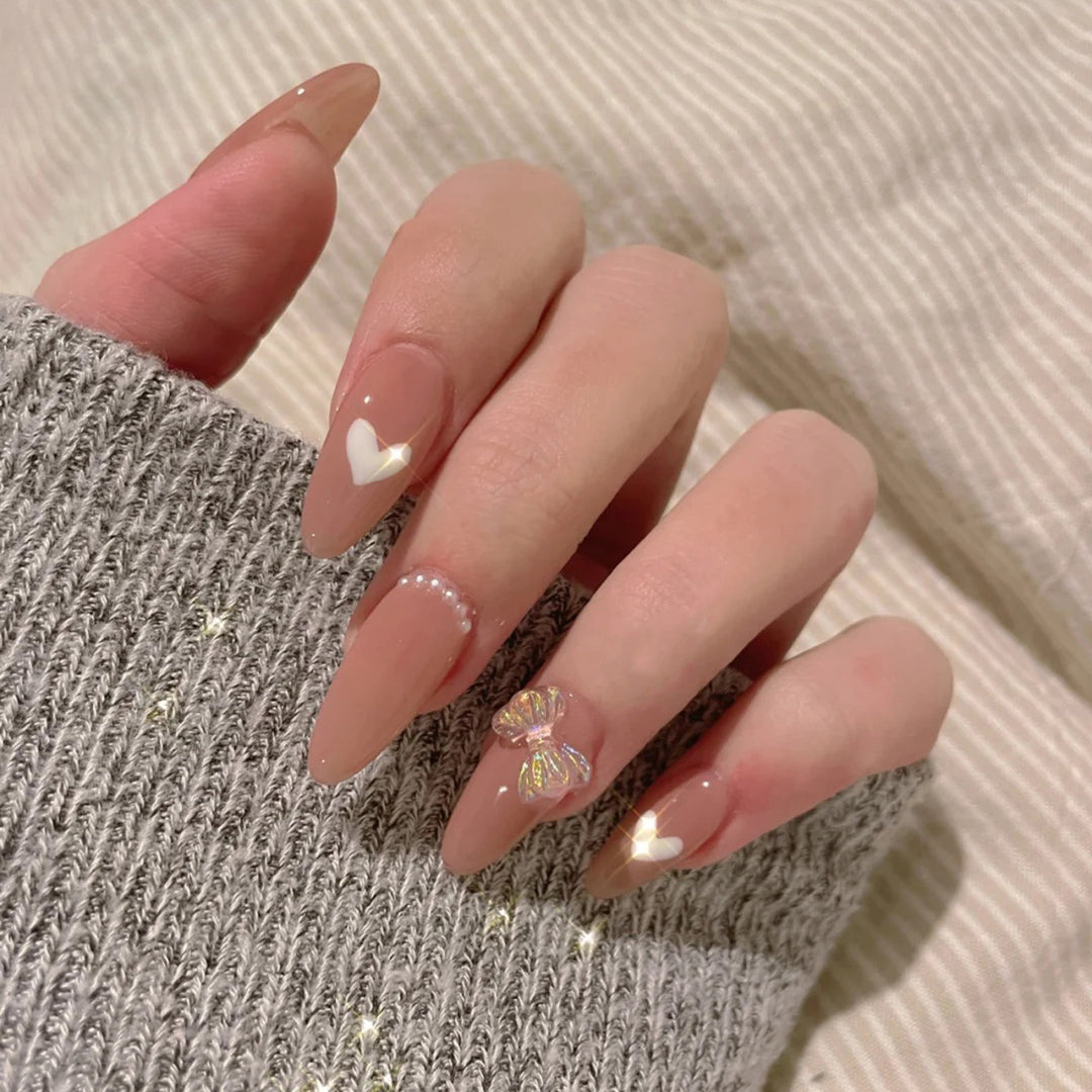 Elegant artificial nails with heart-shaped and glitter accents Kalsten