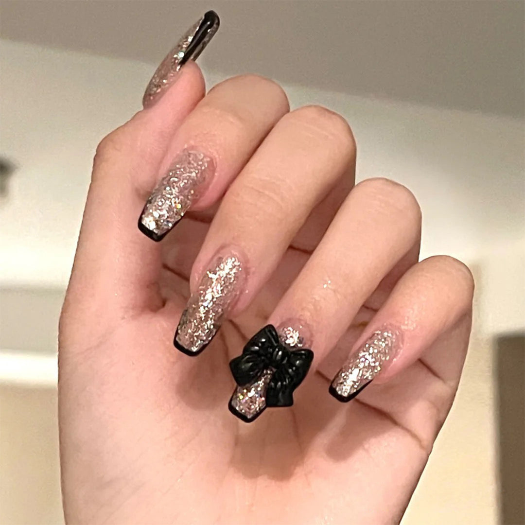 Artistic Nail Extensions with Glitter and Bow Accents Kalsten