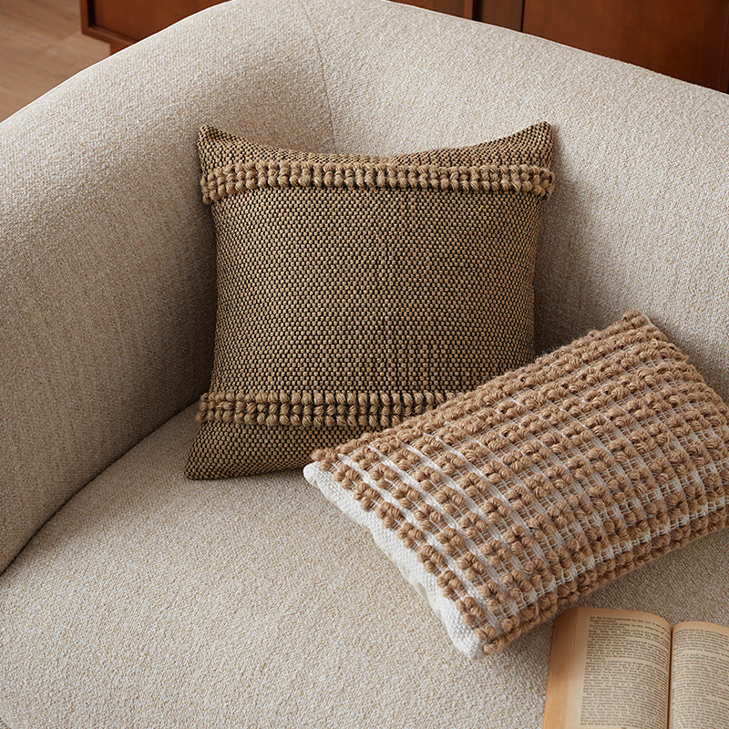 Square Boho decorative cushion made of coarsely woven cotton blend with decorative cord tufts