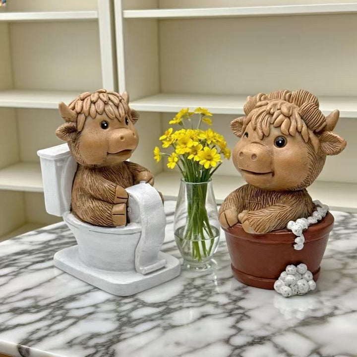 Funny decorative figure of a Highland cow on toilet Kalsten