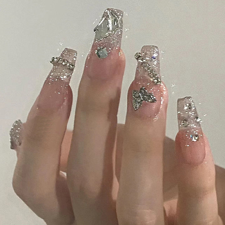 Glamorous artificial nails with delicate flower and glitter effects Kalsten