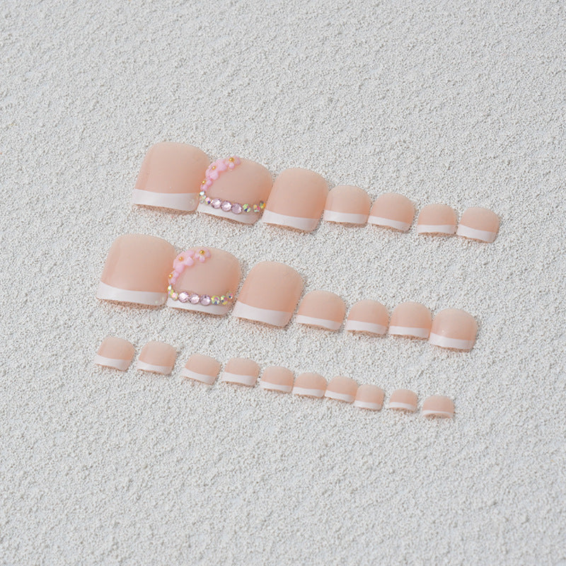 Elegant toenail art with delicate 3D floral decorations Kalsten