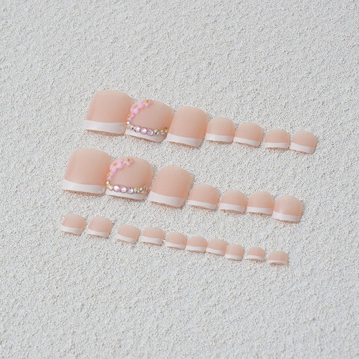 Elegant toenail art with delicate 3D floral decorations Kalsten