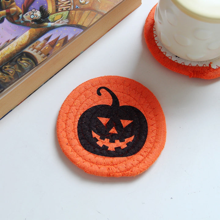 Round felt and cotton coasters with embroidered Halloween haunted house motif