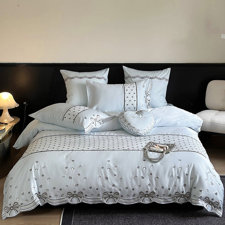 Romantic cotton satin bedding set with embroidered ribbon borders and decorative pillow