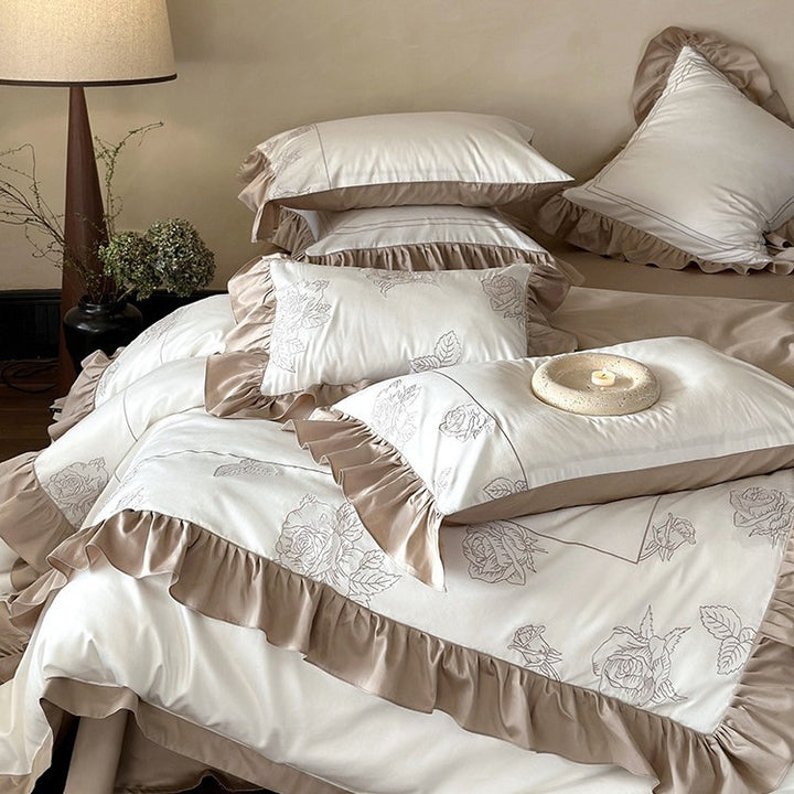 Ruffled bedding set made of cotton satin with rose embroidery and contrast piping