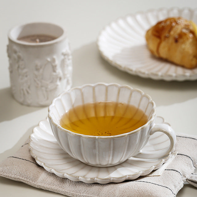 Fine porcelain tea cup set with ribbed shell edge and sculptural handle