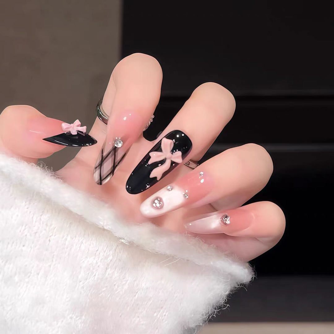 Artificial nails with playful bow and glitter accents Kalsten