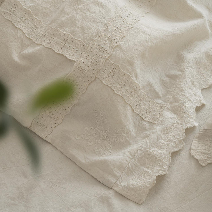 Bed linen set in vintage linen style with lace trim and embroidery detail