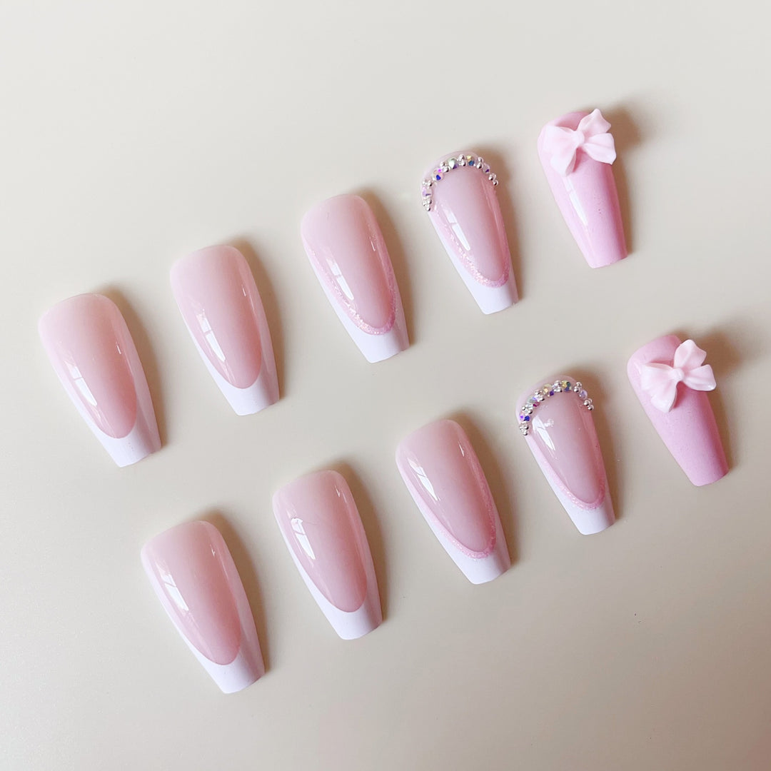 Artificial nail set with playful bows and glitter accents Kalsten