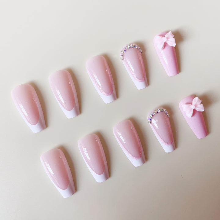 Artificial nail set with playful bows and glitter accents Kalsten