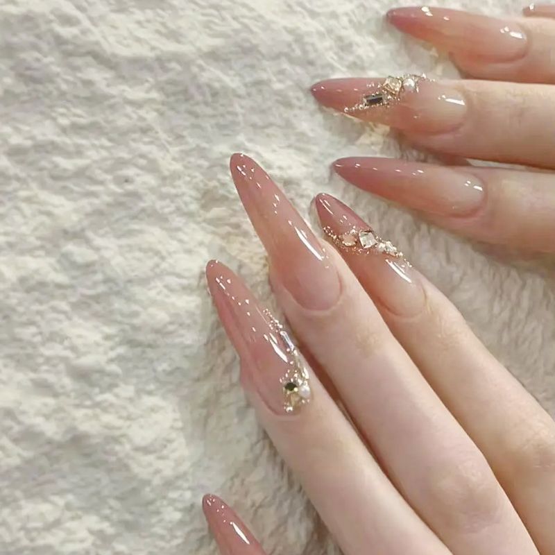 Acrylic nail set with elegant tips and glamorous rhinestone accents Kalsten