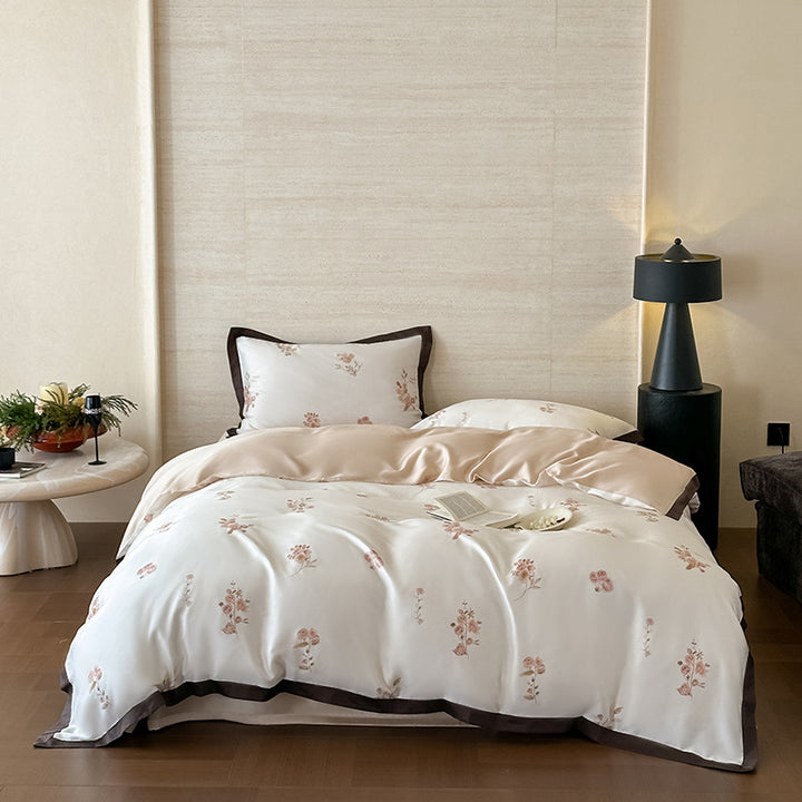 Fine satin duvet cover set with delicate floral embroidery and elegant piping