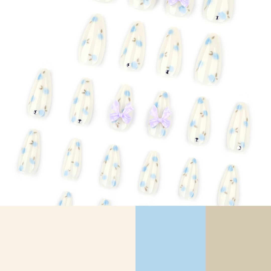 Artful stiletto nails with delicate flower patterns and glitter accents Kalsten