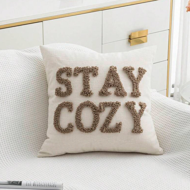 Decorative square cushion cover with hand-tufted lettering made of Bouclé Kalsten