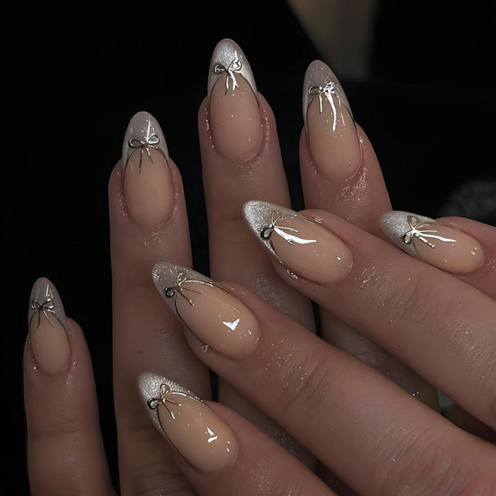 Nail art set with elegant black and white lace design and delicate bow embellishments Kalsten