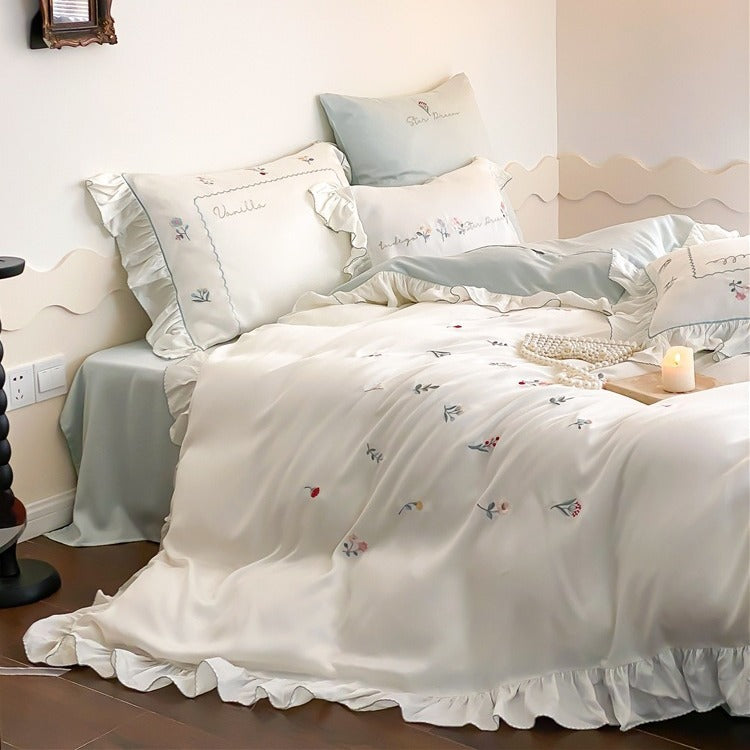 Romantic cotton satin bedding set with delicate floral embroidery and ruffle trim