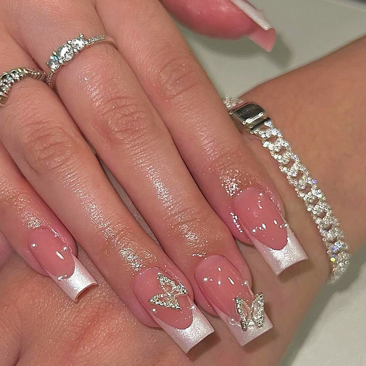 Nail art set with intricate designs and butterfly appliqués Kalsten