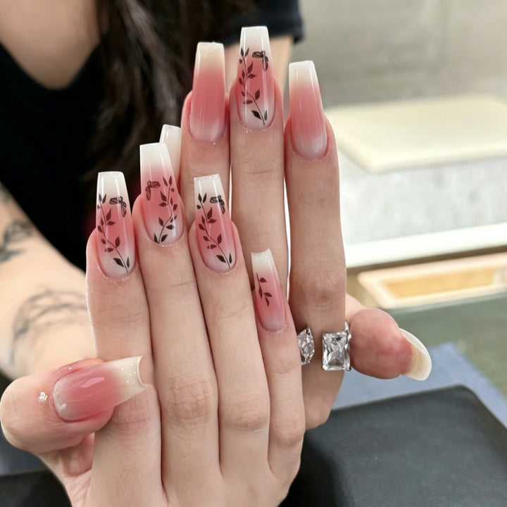 Artificial nails with elegant ombre design and floral accents Kalsten