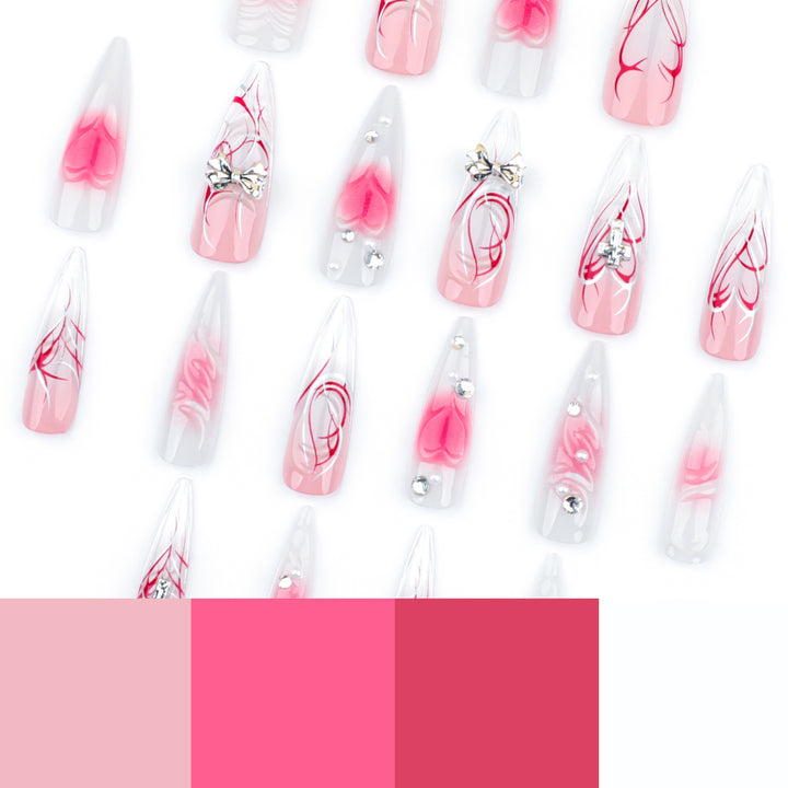 Artful stiletto nails with elegant floral accents and glitter embellishments Kalsten