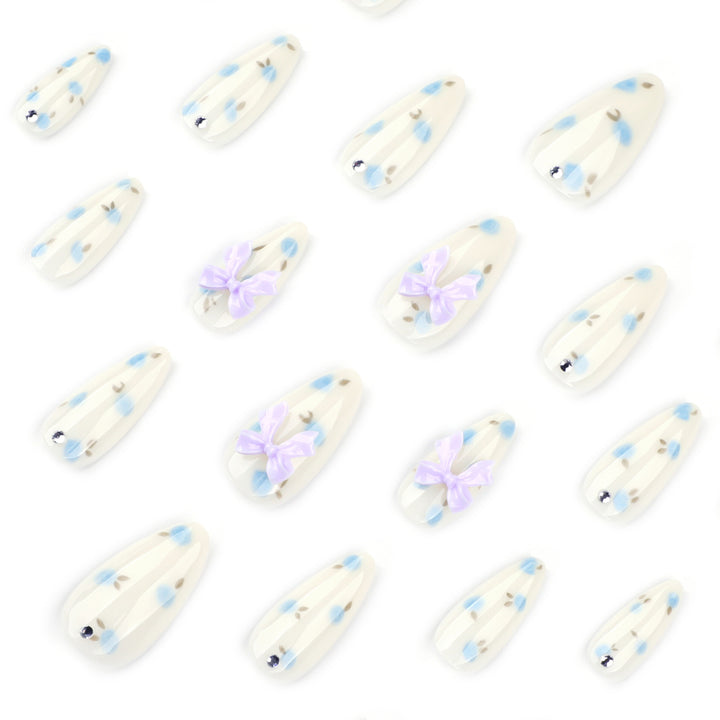 Artful stiletto nails with delicate flower patterns and glitter accents Kalsten