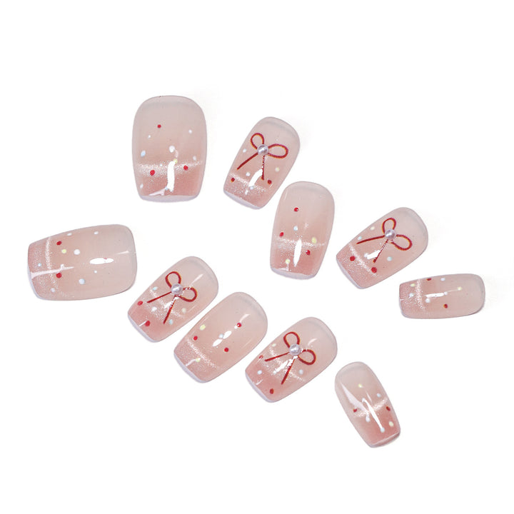 Artificial nail art with elegant bows and glitter accents Kalsten