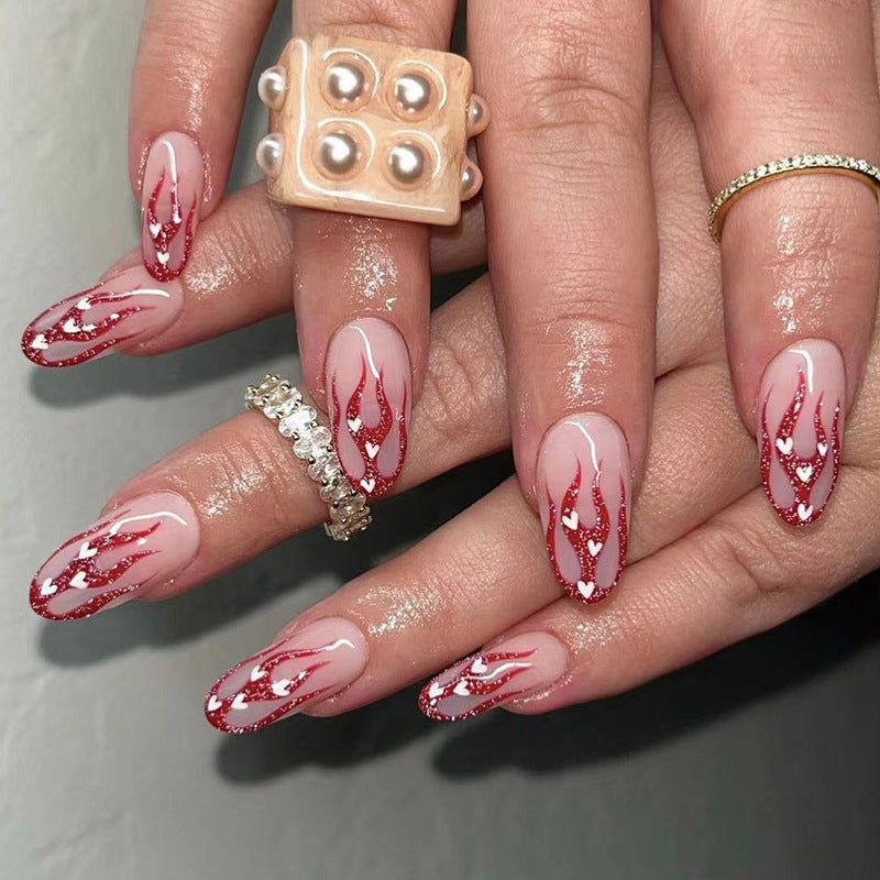 Artificial nail art with romantic heart and flame design Kalsten