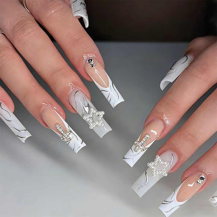 Artificial nails with luxurious marble design and radiant embellishments Kalsten