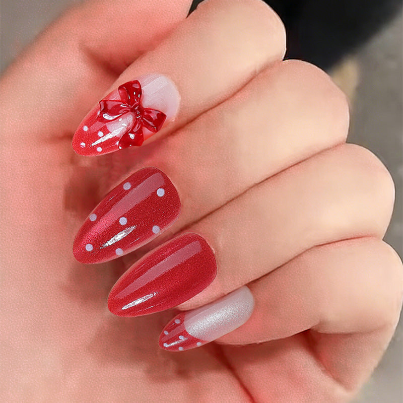 Nail set with playful red polka dots and bow accents Kalsten