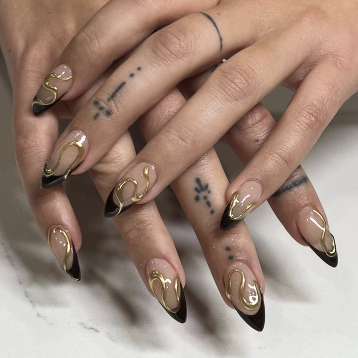 Artful stiletto nails with elegant gold design Kalsten