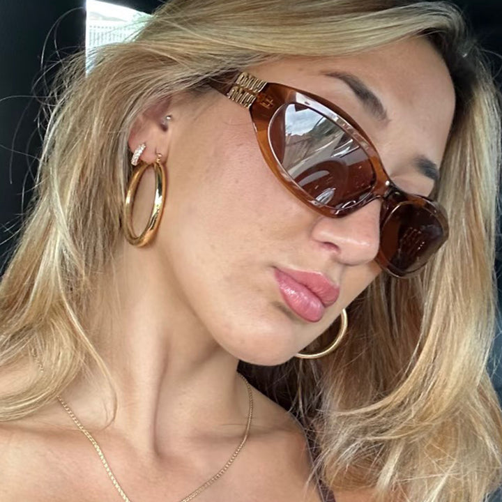 Women’s fashionable sunglasses in a curved design with luxurious details Kalsten
