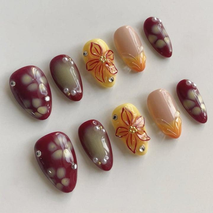 Artificial nail extensions with floral design and rhinestone embellishments Kalsten