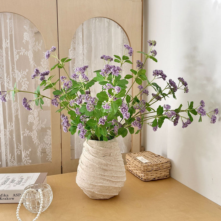 Artificial blossom branch with purple flowers